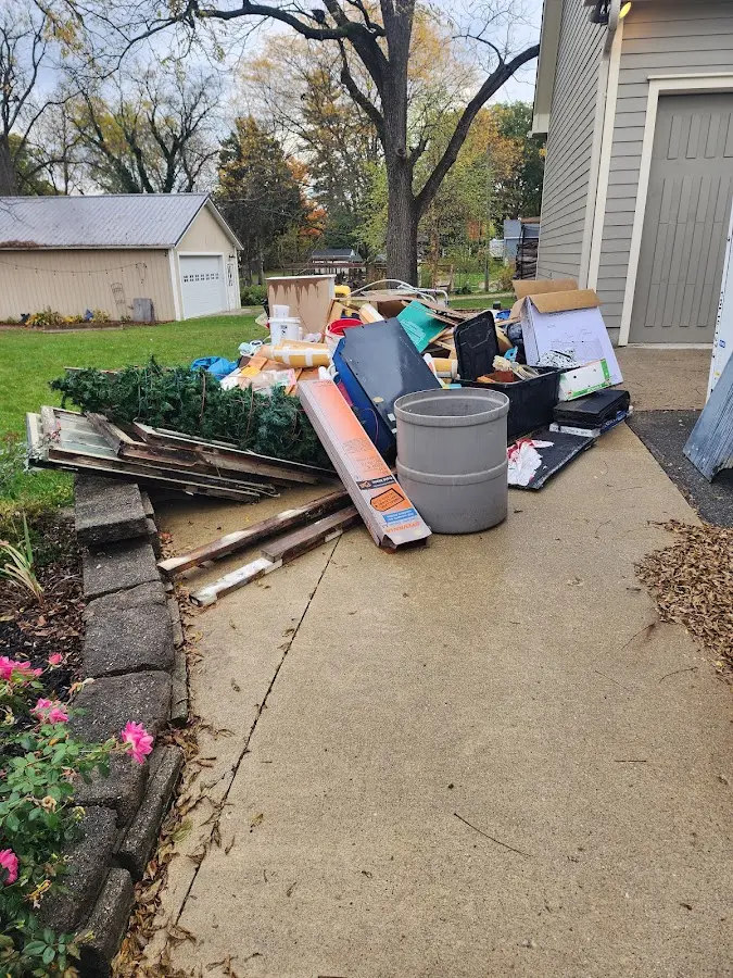 Dumpster being loaded with debris for 12 Yard Dumpster Rental in Kimberly